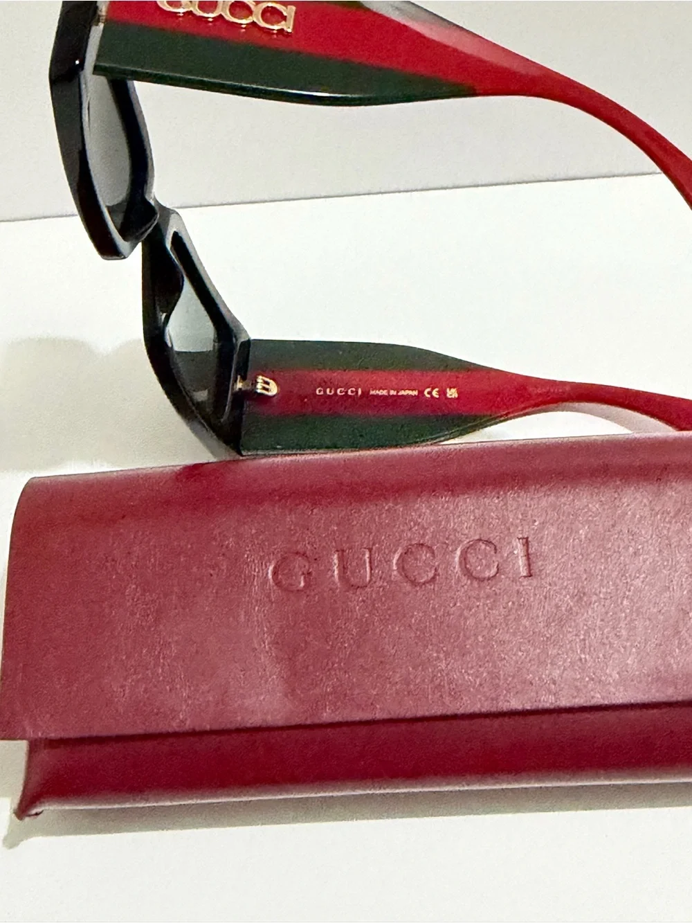 Gucci Black Frame Sunglasses with Red Temples and Gold Logo